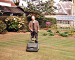Les Catt mowing the lawn